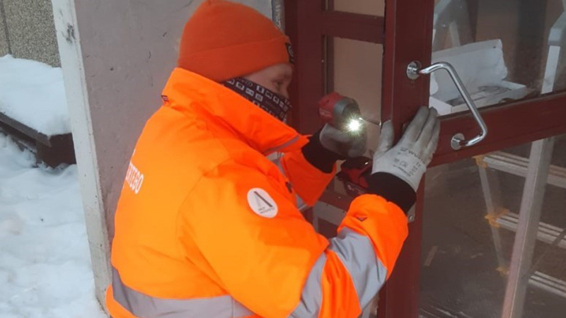 Person installs lock in door